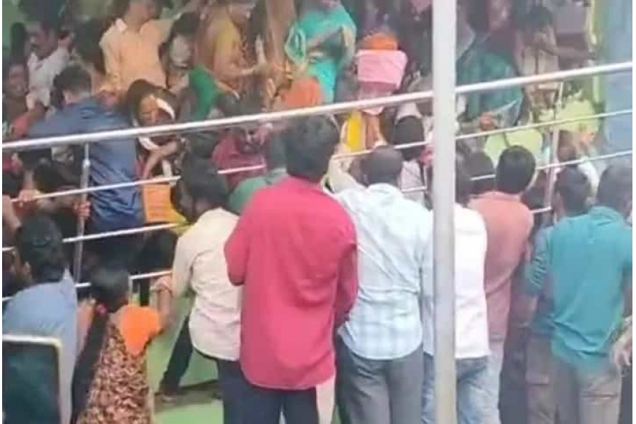 Countless women, carrying puja baskets, are crammed into a small space