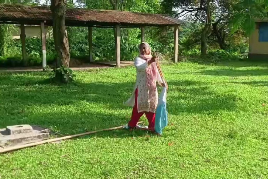 The headmistress folded the national flag lying in the yard with her feet
